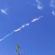 The meteorite leaving a trail in the atmosphere behind it.